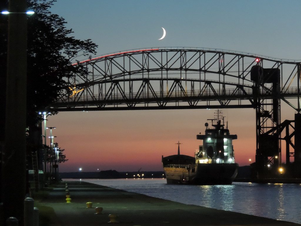 Picture of a barge going under a bridge near the Soo Locks