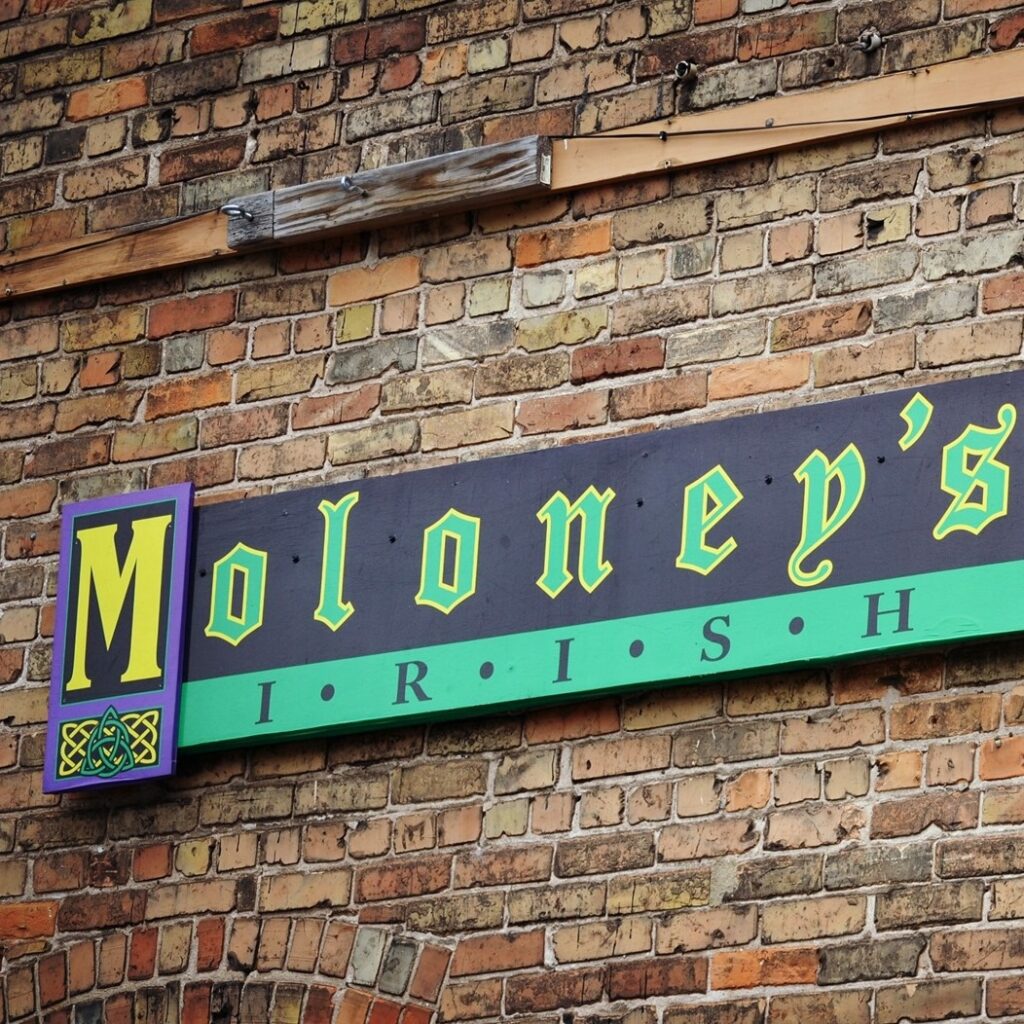 Moloney's Irish sign on brick wall